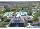 Aerial view of the clubhouse, pools, and tennis courts in a lush, landscaped community at 8005 Cypress Crossing Ct, Tampa, FL 33647