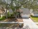 Aerial view of a single-Gathering home nestled in a suburban neighborhood with mature trees and manicured lawns at 9415 Pebble Glen Ave, Tampa, FL 33647