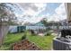 Landscaped backyard featuring a well-manicured lawn and cozy outdoor seating area perfect for entertaining at 9415 Pebble Glen Ave, Tampa, FL 33647