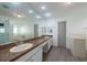 Bright bathroom features double sinks, granite counters, walk-in shower, and separate tub at 9415 Pebble Glen Ave, Tampa, FL 33647