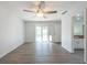 Bright bedroom with wood-look flooring, ceiling fan, and sliding glass door to the outside at 9415 Pebble Glen Ave, Tampa, FL 33647