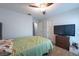 Relaxing bedroom with hardwood floors, ceiling fan, and a closet for ample storage at 9415 Pebble Glen Ave, Tampa, FL 33647