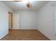 Minimalist bedroom featuring hardwood floors, a bright window, and a ceiling fan at 9415 Pebble Glen Ave, Tampa, FL 33647