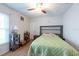 Comfortable bedroom featuring a ceiling fan, wood-look flooring, and bright natural light at 9415 Pebble Glen Ave, Tampa, FL 33647