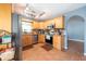 Bright kitchen boasts stainless appliances, wood cabinets, recessed lighting, and tile floors at 9415 Pebble Glen Ave, Tampa, FL 33647