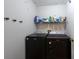 Laundry room with modern washer and dryer, and a shelf for storage at 9415 Pebble Glen Ave, Tampa, FL 33647