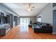 Spacious living room features gleaming hardwood floors and sliding glass doors to the pool at 9415 Pebble Glen Ave, Tampa, FL 33647