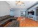 Open-concept living room with a large sectional couch and hardwood floors at 9415 Pebble Glen Ave, Tampa, FL 33647