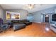 Cozy living room showcasing hardwood floors, a comfortable couch, and views of the kitchen at 9415 Pebble Glen Ave, Tampa, FL 33647