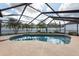 Sparkling swimming pool surrounded by a screen enclosure, perfect for relaxation and outdoor enjoyment at 9415 Pebble Glen Ave, Tampa, FL 33647