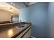 Compact wet bar area featuring a sink, countertop, and cabinetry at 9415 Pebble Glen Ave, Tampa, FL 33647