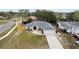 Beautiful aerial view of a single-Gathering home showcasing its roof, driveway, yard, and surrounding neighborhood at 10424 Gifford Dr, Spring Hill, FL 34608