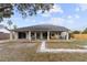 A lovely home backyard with a covered patio, ideal for outdoor dining and entertainment at 10424 Gifford Dr, Spring Hill, FL 34608