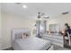 This bedroom features a ceiling fan, natural light, and a clean, neutral color scheme at 10424 Gifford Dr, Spring Hill, FL 34608