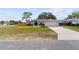 Beautiful single-story home with a well-maintained lawn and a long driveway leading to the attached garage at 10424 Gifford Dr, Spring Hill, FL 34608