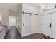 Open foyer featuring wood flooring, barn door, and view into other rooms at 10424 Gifford Dr, Spring Hill, FL 34608