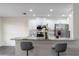 Eat-in kitchen featuring stainless steel appliances, white cabinetry, and elegant countertops with bar stool seating at 10424 Gifford Dr, Spring Hill, FL 34608