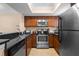 Modern kitchen featuring stainless steel appliances and dark countertops, combining elegance and practicality at 1102 Montrose Pl # 1704, Dunedin, FL 34698