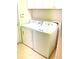 Bright laundry area features modern appliances and ample storage with upper cabinets at 11477 Tinder Ct, Venice, FL 34292