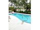 Inviting in-ground pool with screened enclosure offers relaxing outdoor living and a beautiful water view at 11477 Tinder Ct, Venice, FL 34292