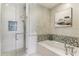 Chic bathroom with frameless glass shower, soaking tub, and upscale fixtures surrounded by decorative tile work at 1209 E Cumberland Ave # 2802, Tampa, FL 33602
