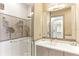 Bathroom with a glass shower stall and vanity with sink and a large mirror above at 1209 E Cumberland Ave # 2802, Tampa, FL 33602