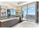 Beautiful primary bathroom with dual sinks, large window, and soaking tub overlooking bay at 1209 E Cumberland Ave # 2802, Tampa, FL 33602