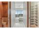 Open doorway view into the bedroom with light hardwood floors and large windows with city views at 1209 E Cumberland Ave # 2802, Tampa, FL 33602