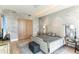 Comfortable bedroom featuring a large bed, wood floors, textured walls, and plenty of natural light at 1209 E Cumberland Ave # 2802, Tampa, FL 33602