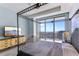 Elegant bedroom features a wrought iron canopy bed, a TV, a dresser, and a scenic balcony with city views at 1209 E Cumberland Ave # 2802, Tampa, FL 33602