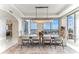 Dining room with modern light fixture, floor-to-ceiling windows, and picturesque city views at 1209 E Cumberland Ave # 2802, Tampa, FL 33602