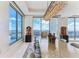 Elegant dining room boasts a long table, modern chandelier, and expansive windows offering breathtaking city views at 1209 E Cumberland Ave # 2802, Tampa, FL 33602