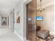Hallway with tile flooring, textured walls, decorative statue, and a glimpse of a living room with television at 1209 E Cumberland Ave # 2802, Tampa, FL 33602