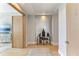 Elegant hallway with light wood floors and decorative display shelf and artistic decor at 1209 E Cumberland Ave # 2802, Tampa, FL 33602