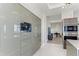 Spacious kitchen featuring a large refrigerator, stainless steel microwave, and view of a comfortable sitting area at 1209 E Cumberland Ave # 2802, Tampa, FL 33602