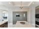 Contemporary kitchen featuring custom cabinets, stainless steel appliances, chandelier, and open access to living area at 1209 E Cumberland Ave # 2802, Tampa, FL 33602