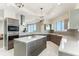 Open kitchen with stainless steel microwave, oven, custom cabinets, a large island with seating, and modern lighting at 1209 E Cumberland Ave # 2802, Tampa, FL 33602