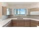 Modern kitchen featuring sleek wood cabinets, stainless steel sink, and a large window with city and water views at 1209 E Cumberland Ave # 2802, Tampa, FL 33602