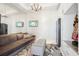 Sitting room featuring a velvet couch, soft ottoman, decorative rug, wall-mounted television, and storage at 1209 E Cumberland Ave # 2802, Tampa, FL 33602