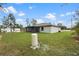 Spacious backyard with a screened lanai, mature trees, and a well-maintained lawn, ideal for outdoor living at 12341 Filbert Rd, Weeki Wachee, FL 34614
