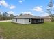 Well-manicured lawn and screened-in patio highlight the property's backyard, offering a private and serene outdoor space at 12341 Filbert Rd, Weeki Wachee, FL 34614