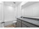 Modern bathroom featuring a granite countertop, gray cabinets and tiled shower at 12341 Filbert Rd, Weeki Wachee, FL 34614