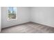 Bright bedroom featuring a window providing natural light and neutral carpet at 12341 Filbert Rd, Weeki Wachee, FL 34614