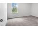 Bright bedroom featuring a window providing natural light and neutral carpet at 12341 Filbert Rd, Weeki Wachee, FL 34614