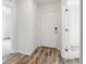 Bright entryway features modern wood-look floors, a white door with a digital lock, and white trim at 12341 Filbert Rd, Weeki Wachee, FL 34614