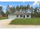 Charming one-story home featuring a 2-car garage, lush green lawn and manicured landscaping at 12341 Filbert Rd, Weeki Wachee, FL 34614