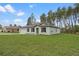Charming single-story home features a well-maintained lawn, neutral paint, a two-car garage, and classic black shutters at 12341 Filbert Rd, Weeki Wachee, FL 34614