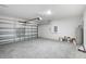 Spacious two-car garage offering ample room for vehicles, storage, and projects, with overhead lighting and concrete flooring at 12341 Filbert Rd, Weeki Wachee, FL 34614