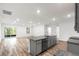 Modern kitchen features an island with granite countertops and stainless steel appliances at 12341 Filbert Rd, Weeki Wachee, FL 34614