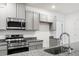 Close up of the modern microwave, oven, granite countertops, and sink in the kitchen at 12341 Filbert Rd, Brooksville, FL 34614